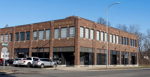 A two-story, multi unit commercial building with a red brick exterior.